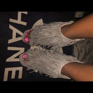 Beige suede fringe heels.